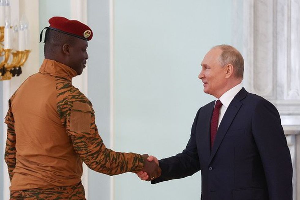 Burkina Faso's President Ibrahim Traore and Russia's President Vladimir Putin shaking hands.