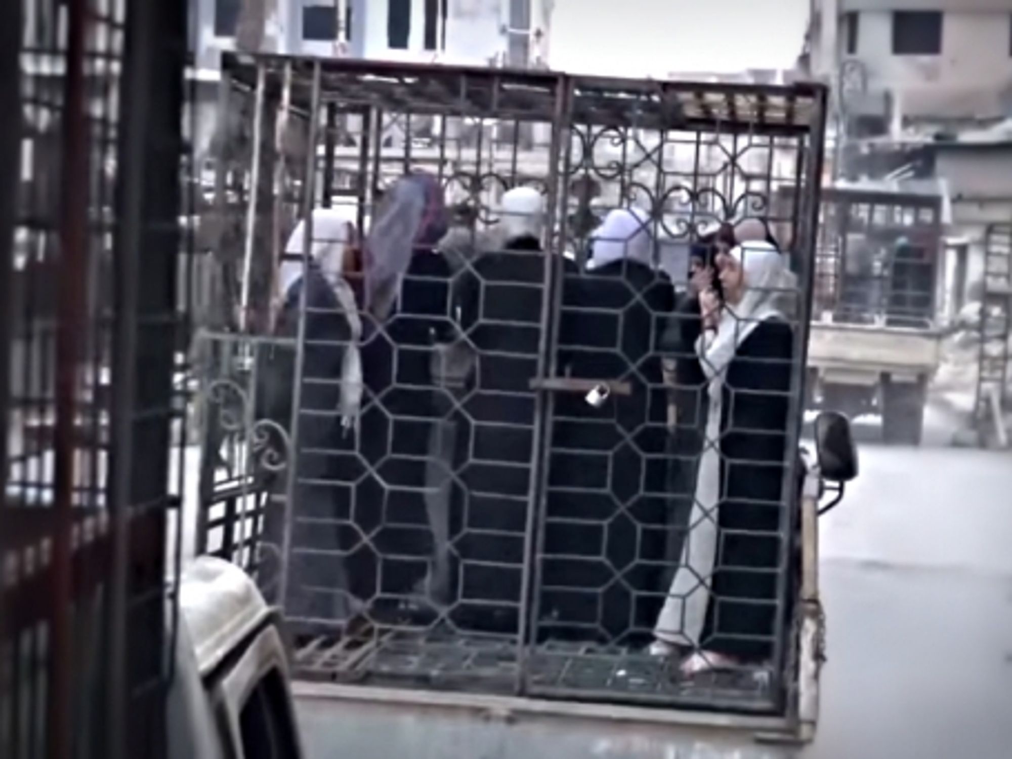 Caged women paraded in Douma