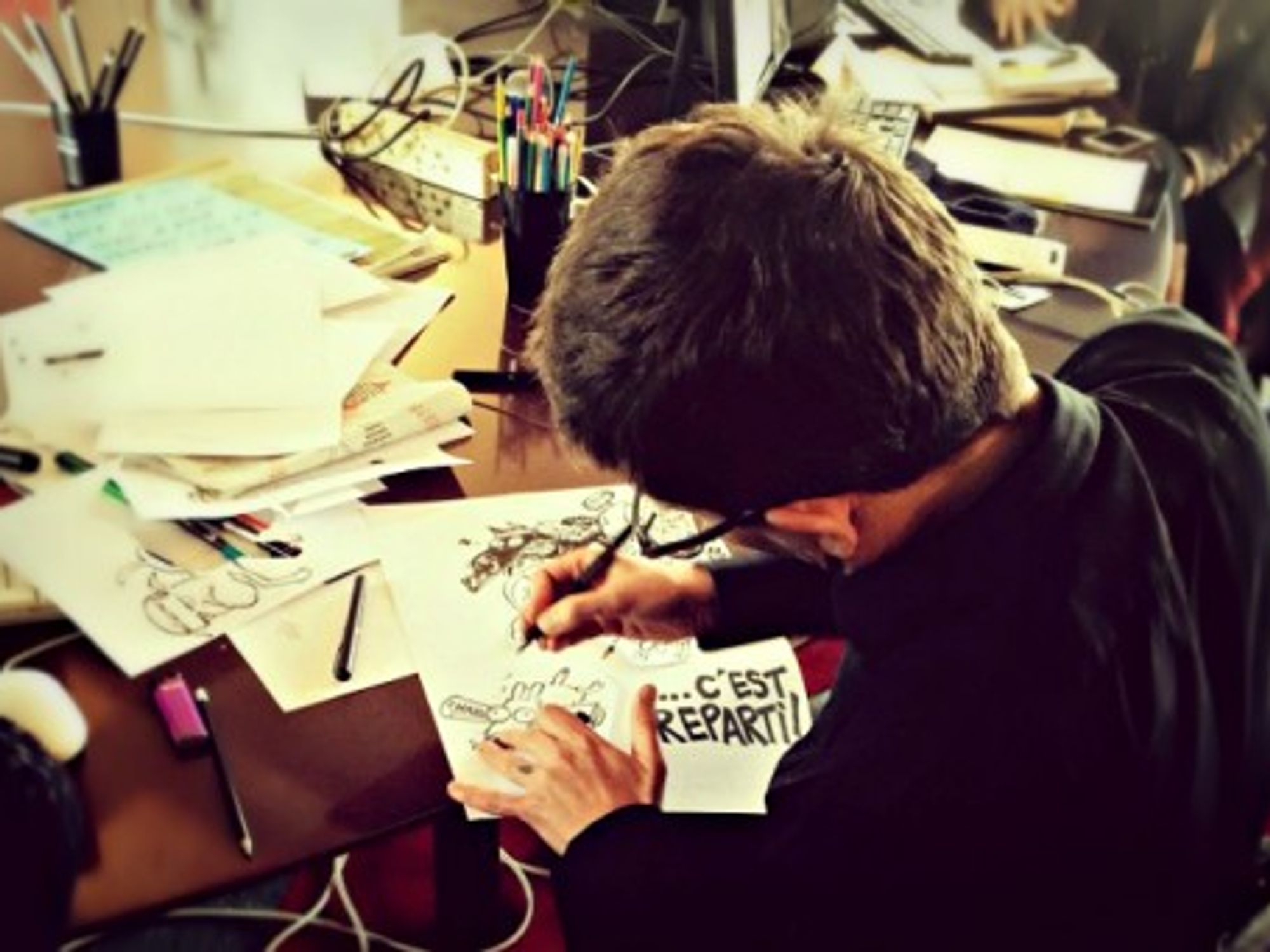 Cartoonist Luz drawing the cover of Charlie's Hebdo Feb. 25 edition