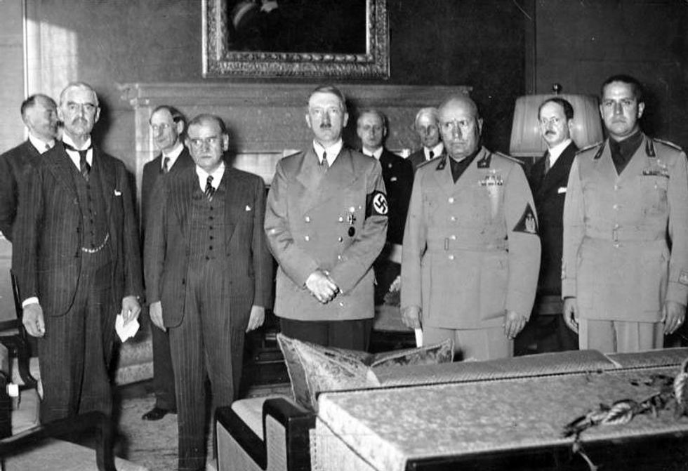 Chamberlain (far left) was Hitler's guest in Munich.