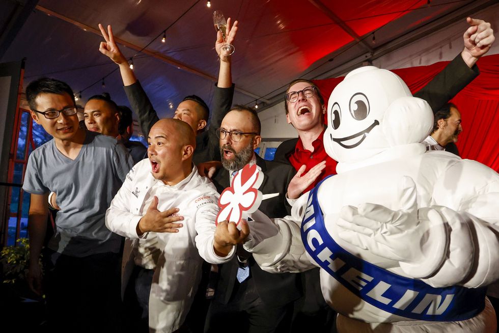 Chef Mike Collantes, owner of Soseki in Orlando, who won a Michelin star rating and is holding the award, celebrates during The Michelin Guide reveal at the Ritz-Carlton Orlando, Grande Lakes, in Orlando