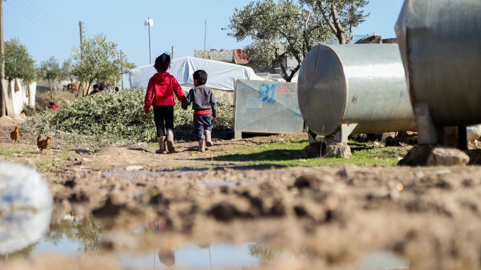 Children amid make-shift tents in the flooded displacement camp of Jindires in the Aleppo governorate, following a recent rainfall.