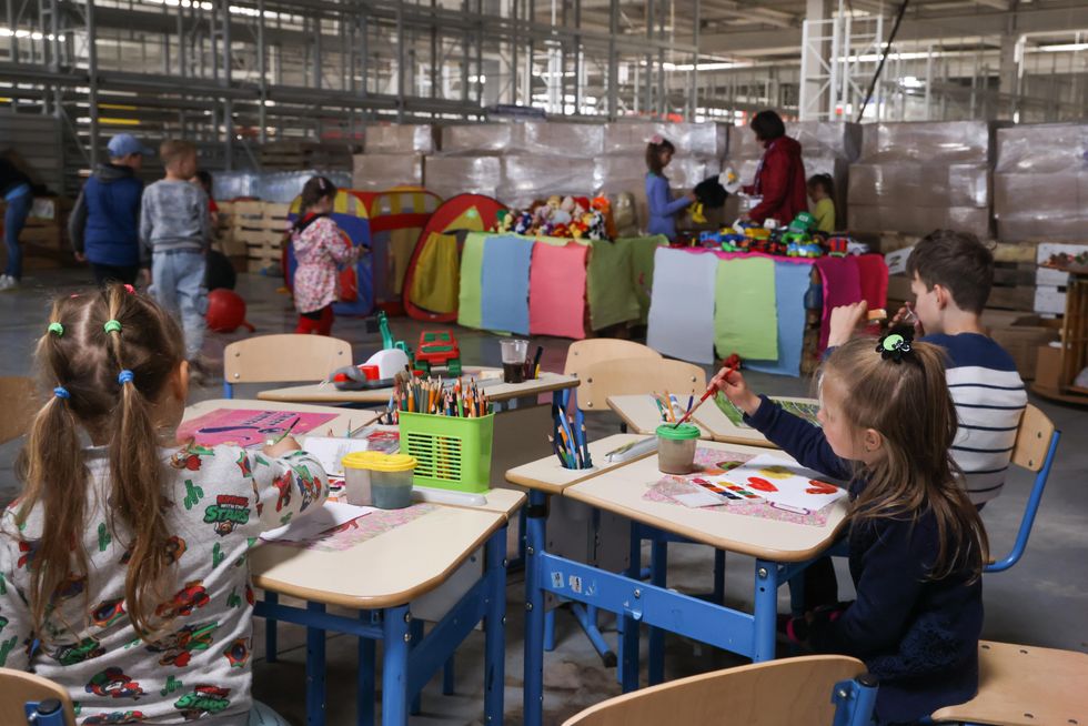 Children are seen at a humanitarian aid distribution center in Mariupol