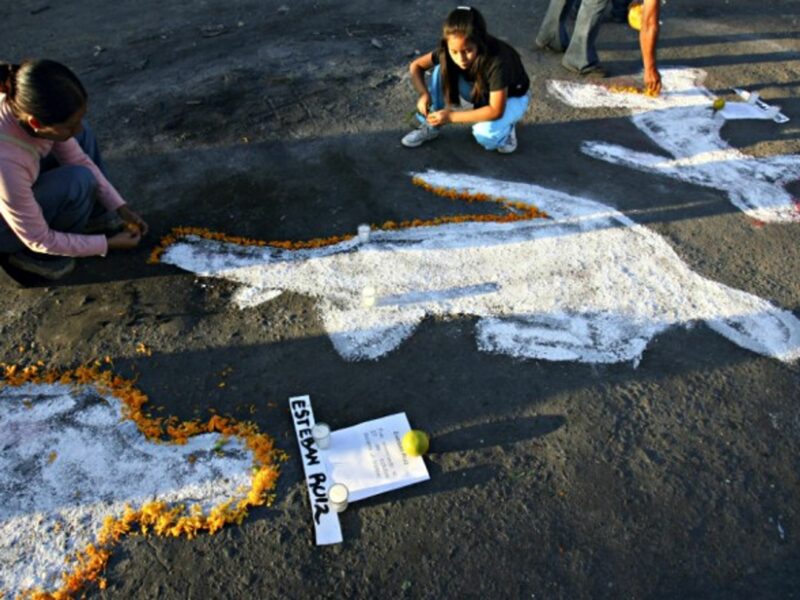 Children decorating chalk outlines in Oaxaca, Mexico