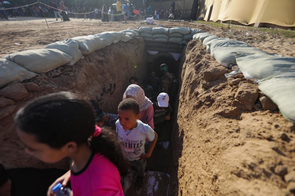 Children exit an underground tunnel in a line