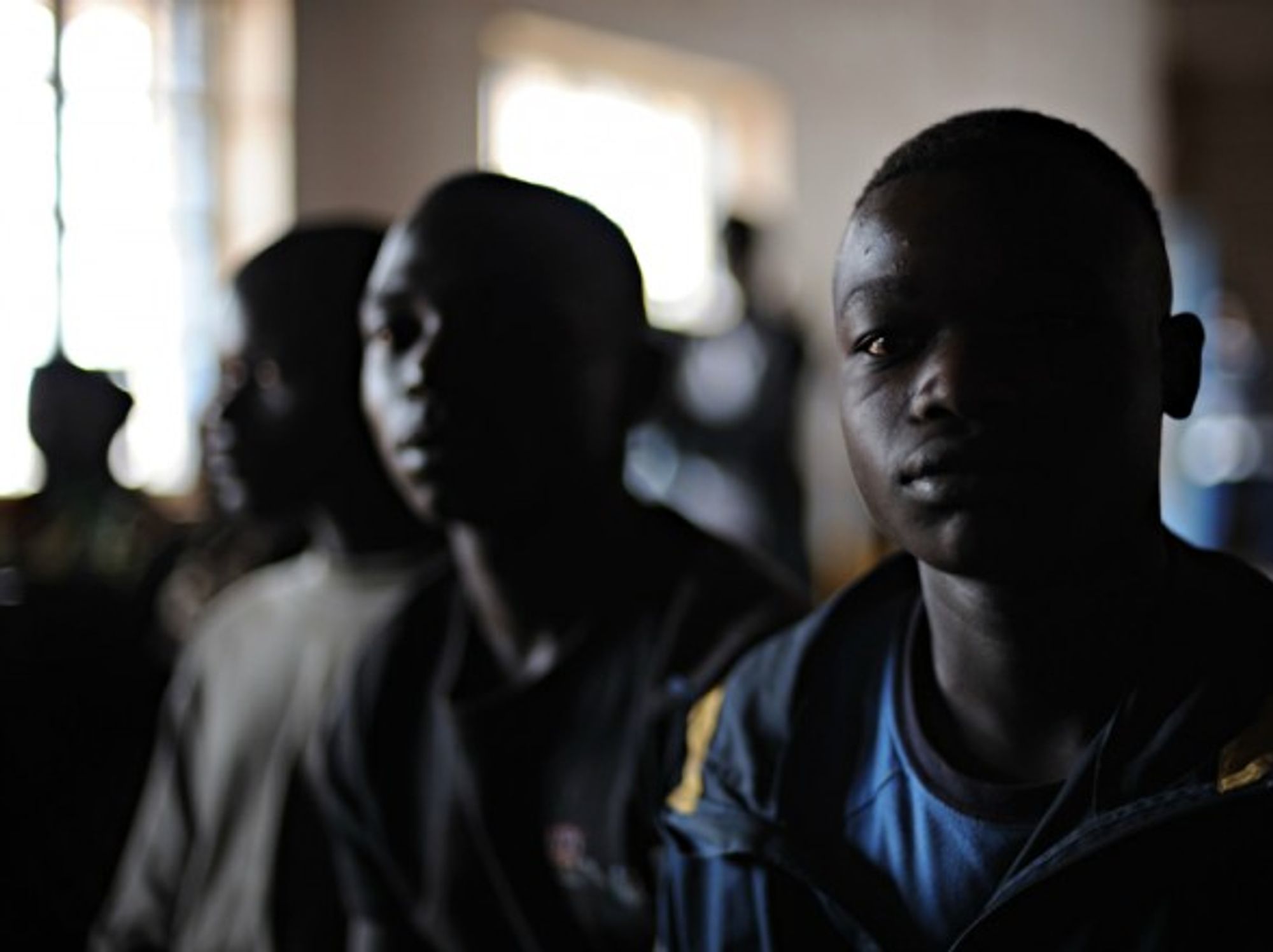 Children sit at a reintegration center in Kpandroma in 2009.