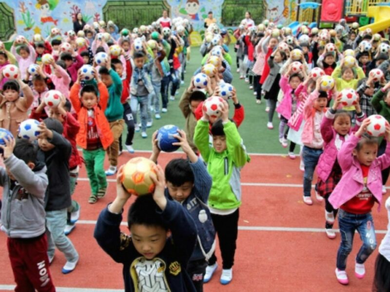 Chinese kindergartners practicing their soccer skills in Zaozhuang