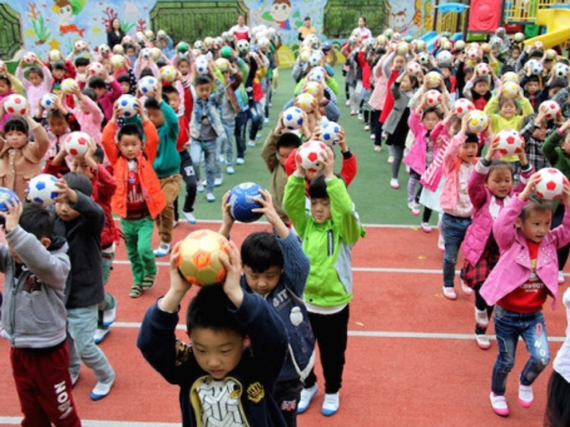 Chinese kindergartners practicing their soccer skills in Zaozhuang