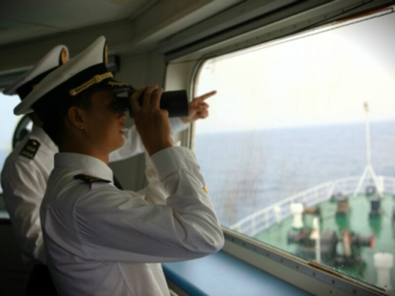 Chinese officers monitor the South China Sea