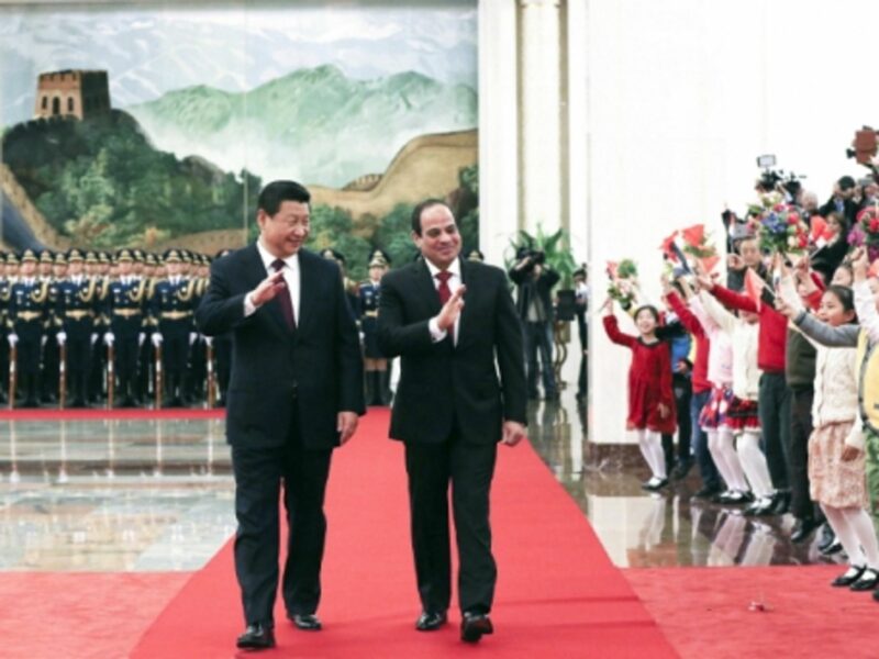 Chinese President Xi Jinping and Egyptian President Abdel Fattah al-Sisi wave to a crowd in Beijing