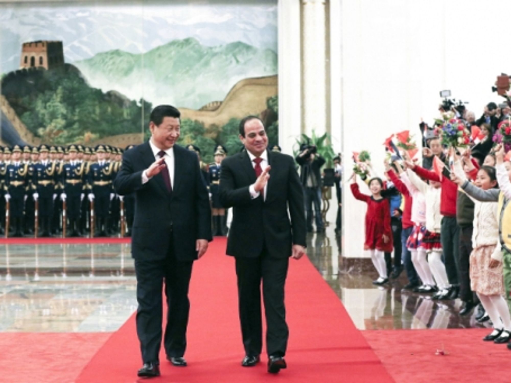 Chinese President Xi Jinping and Egyptian President Abdel Fattah al-Sisi wave to a crowd in Beijing