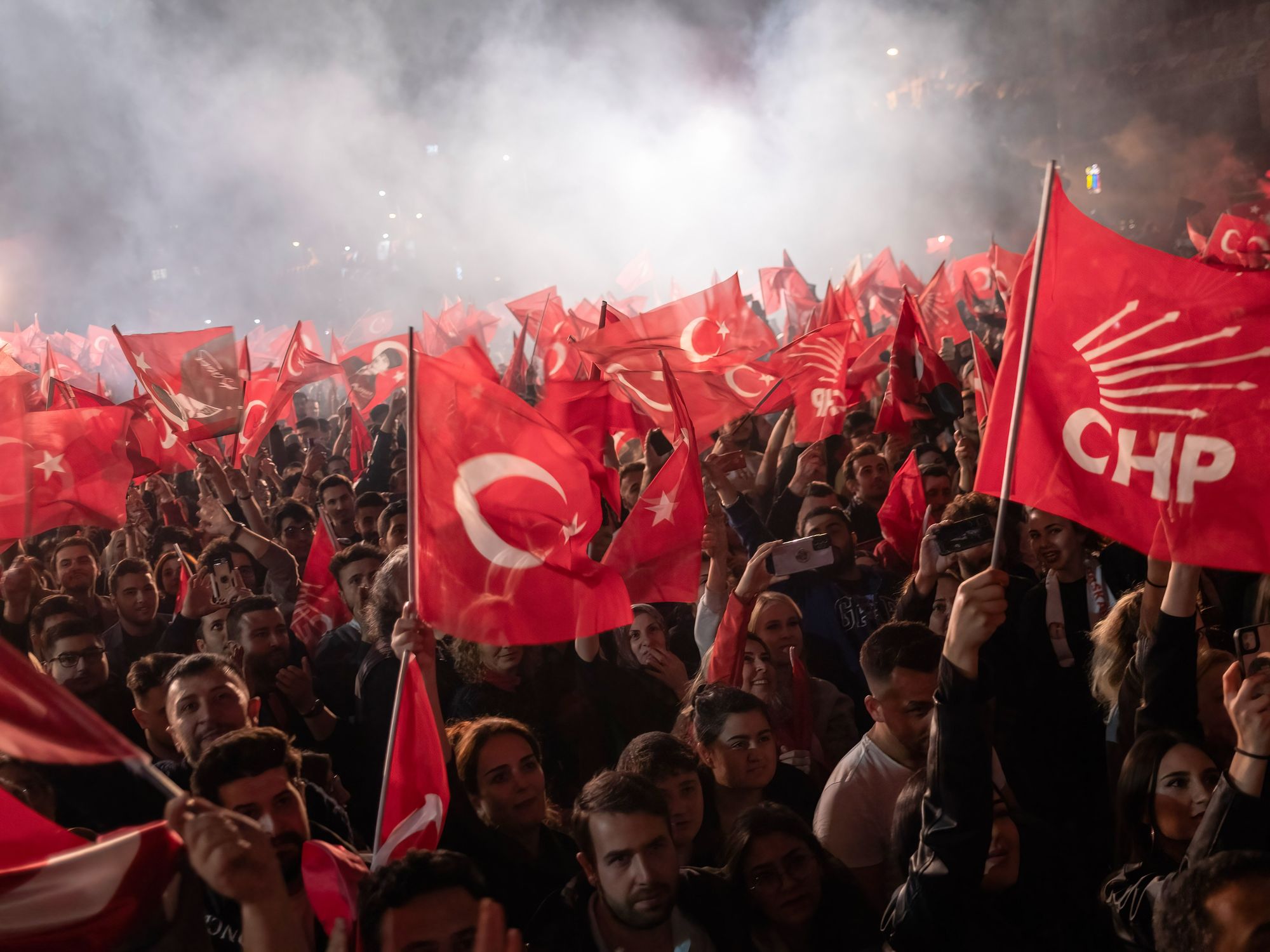 Citizens shout slogans and wave Turkish and CHP party flags during the election victory celebration.