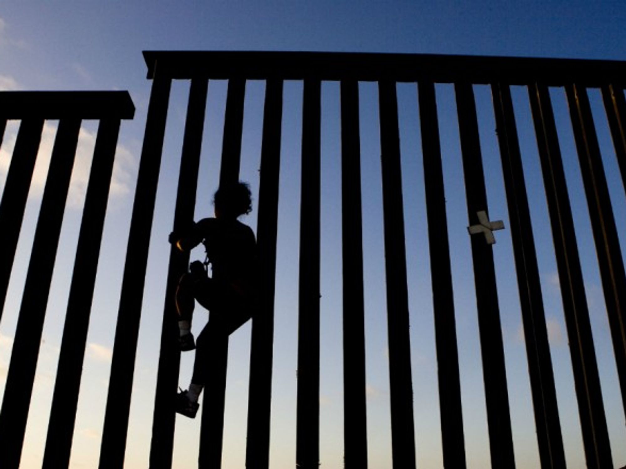 Climbing the fence between U.S. and Mexico in Tijuana