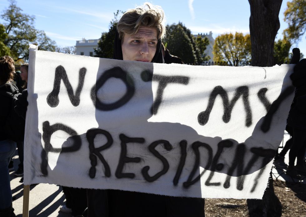 Clinton supporter holds up sign outside White House.