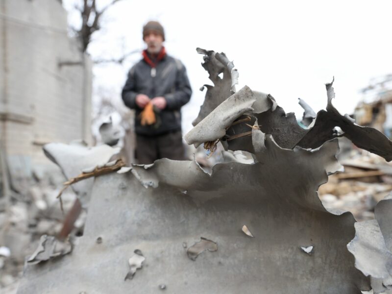 Close up of debris in Melitopol, Ukraine​, with a man standing in the background
