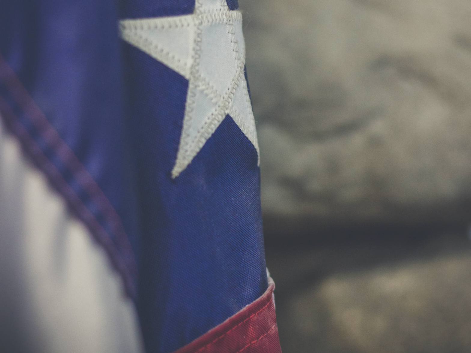 Close up photo of a somber-looking flag of the U.S.