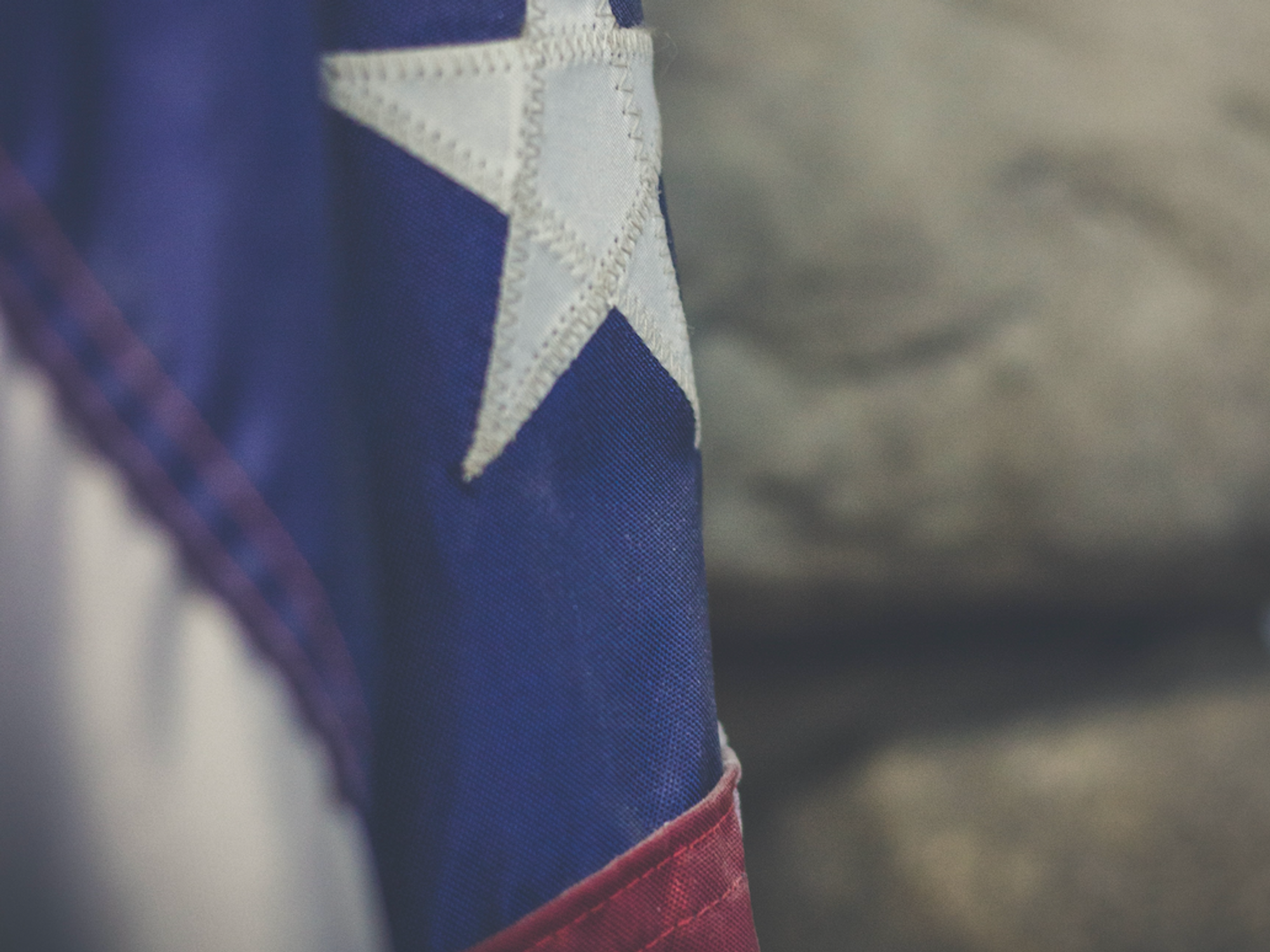 Close up photo of a somber-looking flag of the U.S.