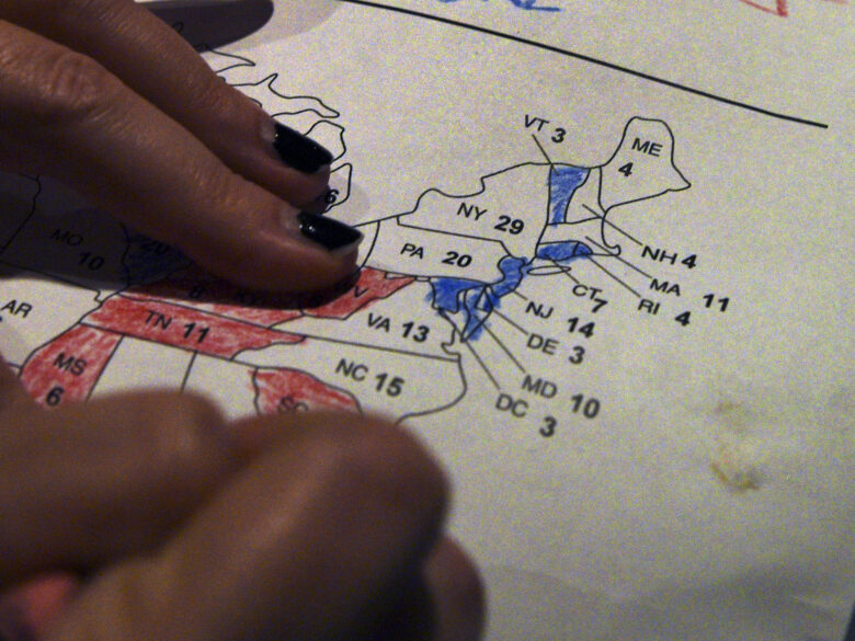 Close up photo on a woman's hands coloring a map of U.S. presidential results at a U.S. election watch party back in 2016