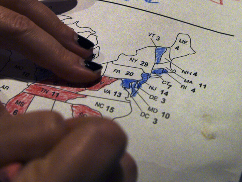 Close up photo on a woman's hands coloring a map of U.S. presidential results at a U.S. election watch party back in 2016