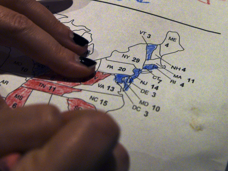 Close up photo on a woman's hands coloring a map of U.S. presidential results at a U.S. election watch party back in 2016