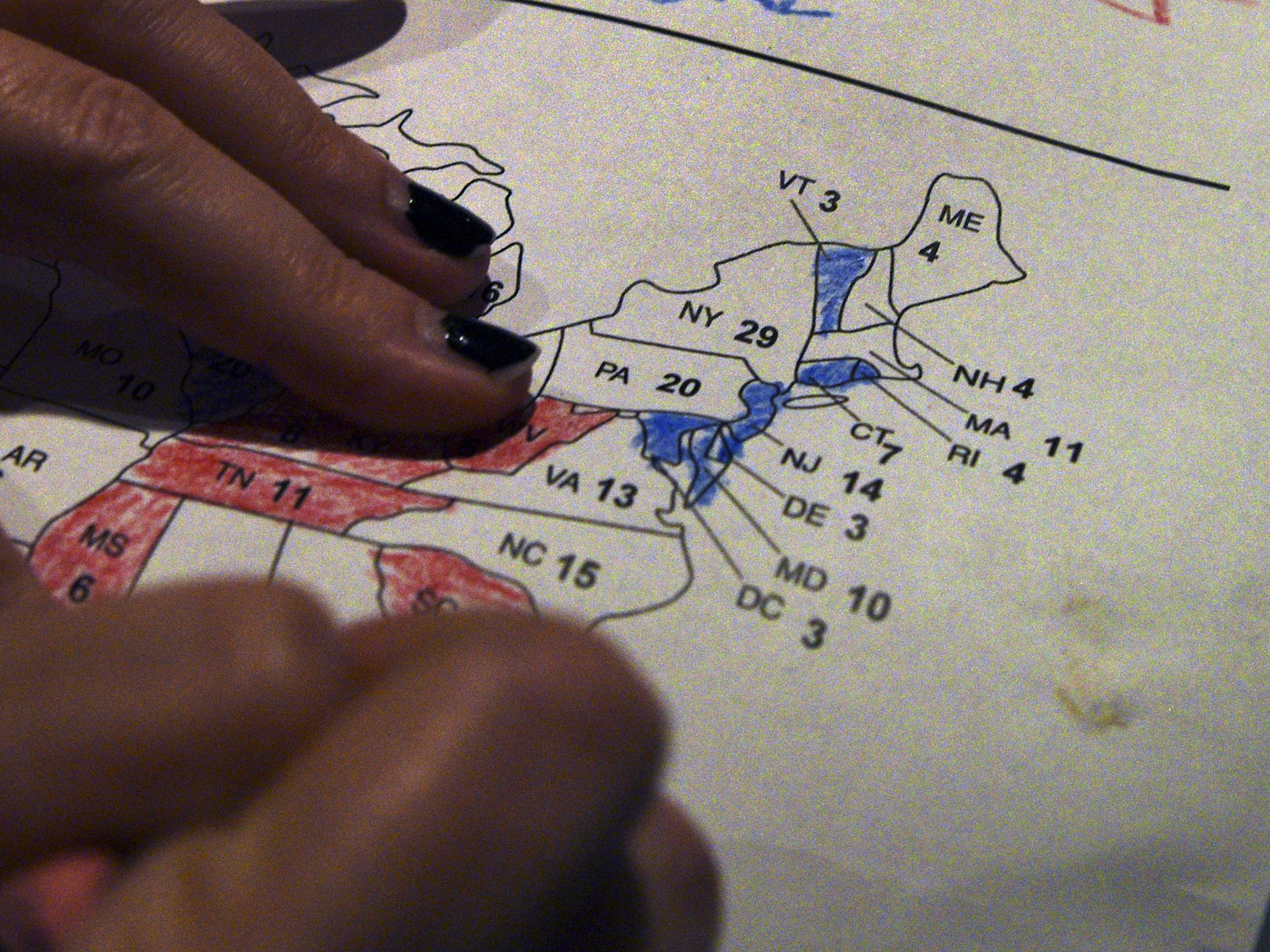 Close up photo on a woman's hands coloring a map of U.S. presidential results at a U.S. election watch party back in 2016