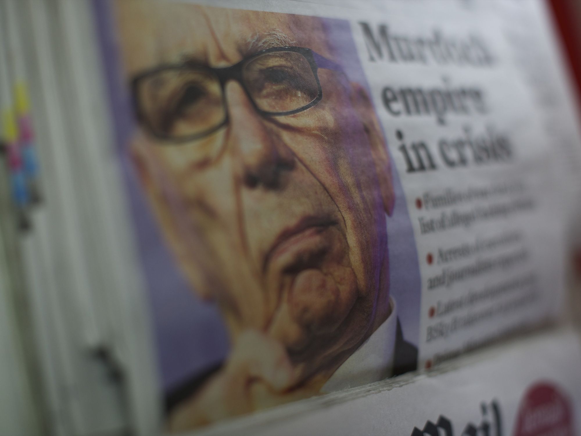 Close up photograph of a opy of The Independent features Rupert Murdoch striking a pensive countenance as his 'News of the World' tabloid newspaper announced its last edition will run