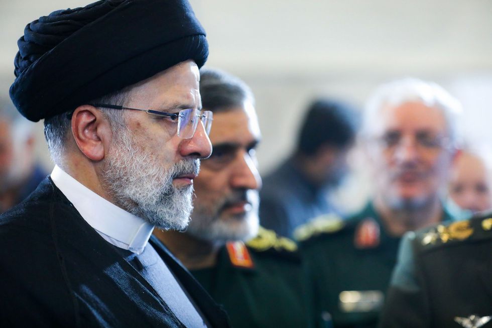 Close up photograph of Iranian President Ebrahim Raisi visiting an exhibit celebrating the achievements of the country's defence industry.