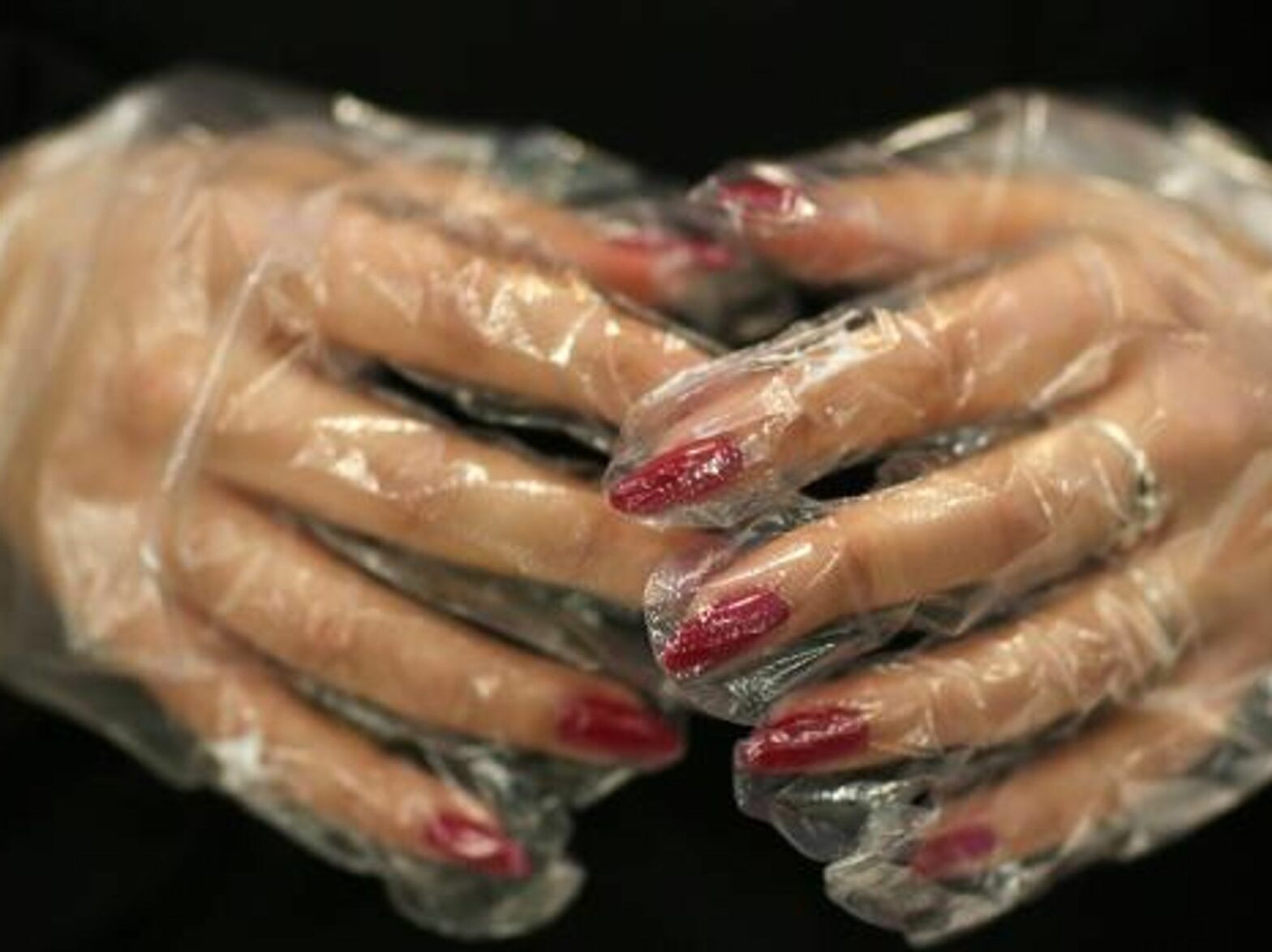 Closeup photo of a woman's hands wearing latex gloves