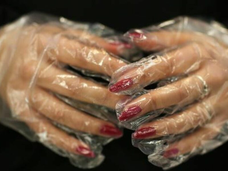 Closeup photo of a woman's hands wearing latex gloves