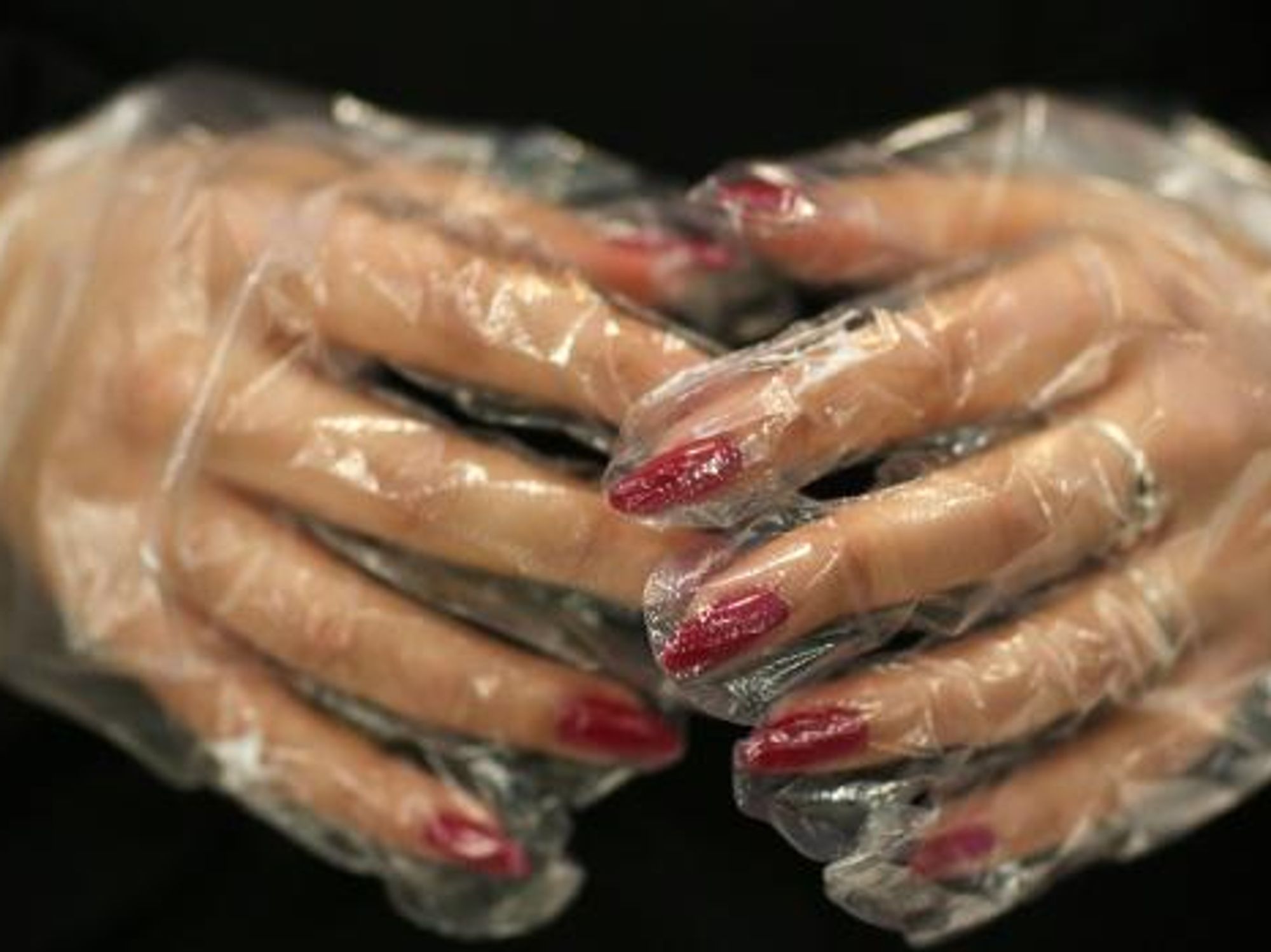 Closeup photo of a woman's hands wearing latex gloves