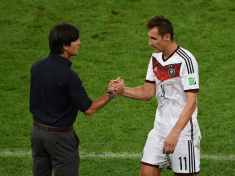 Coach LÃ¶w shakes hands with veteran Miroslav Klose during Sunday's match