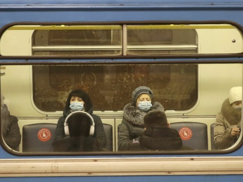 Commuters in face masks on a train in Russia