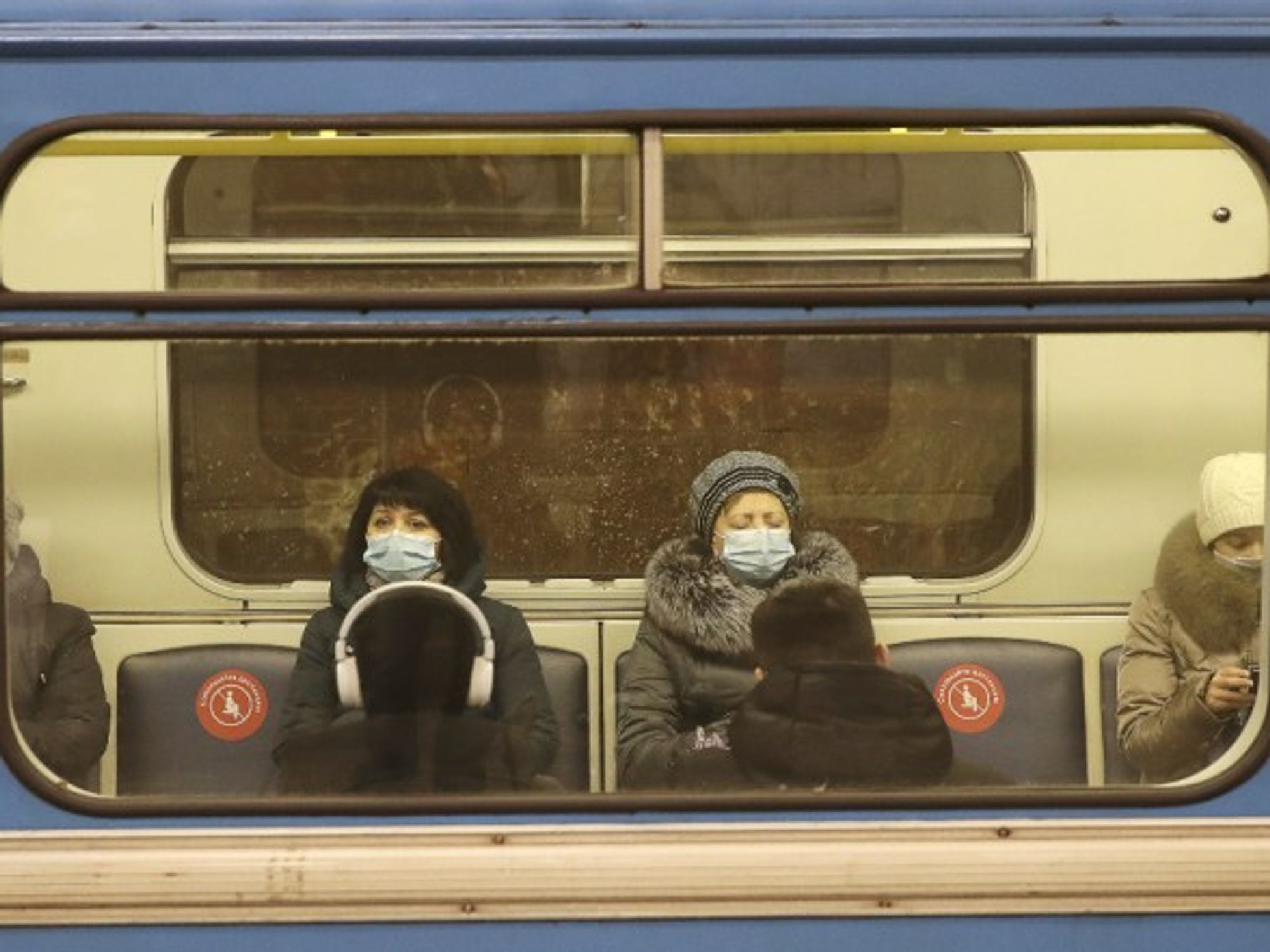 Commuters in face masks on a train in Russia