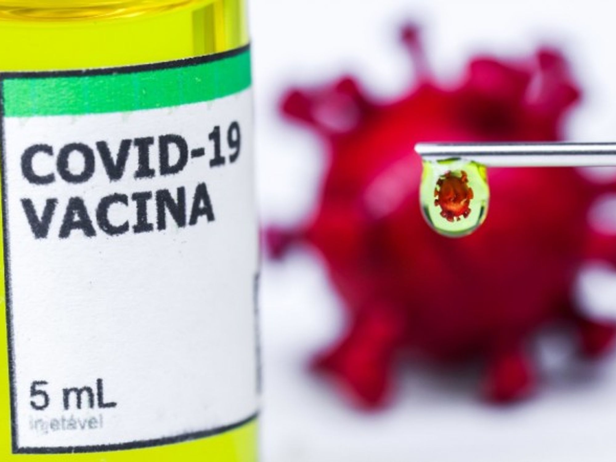 Conceptual vaccine and new coronavirus reflected in a drop.