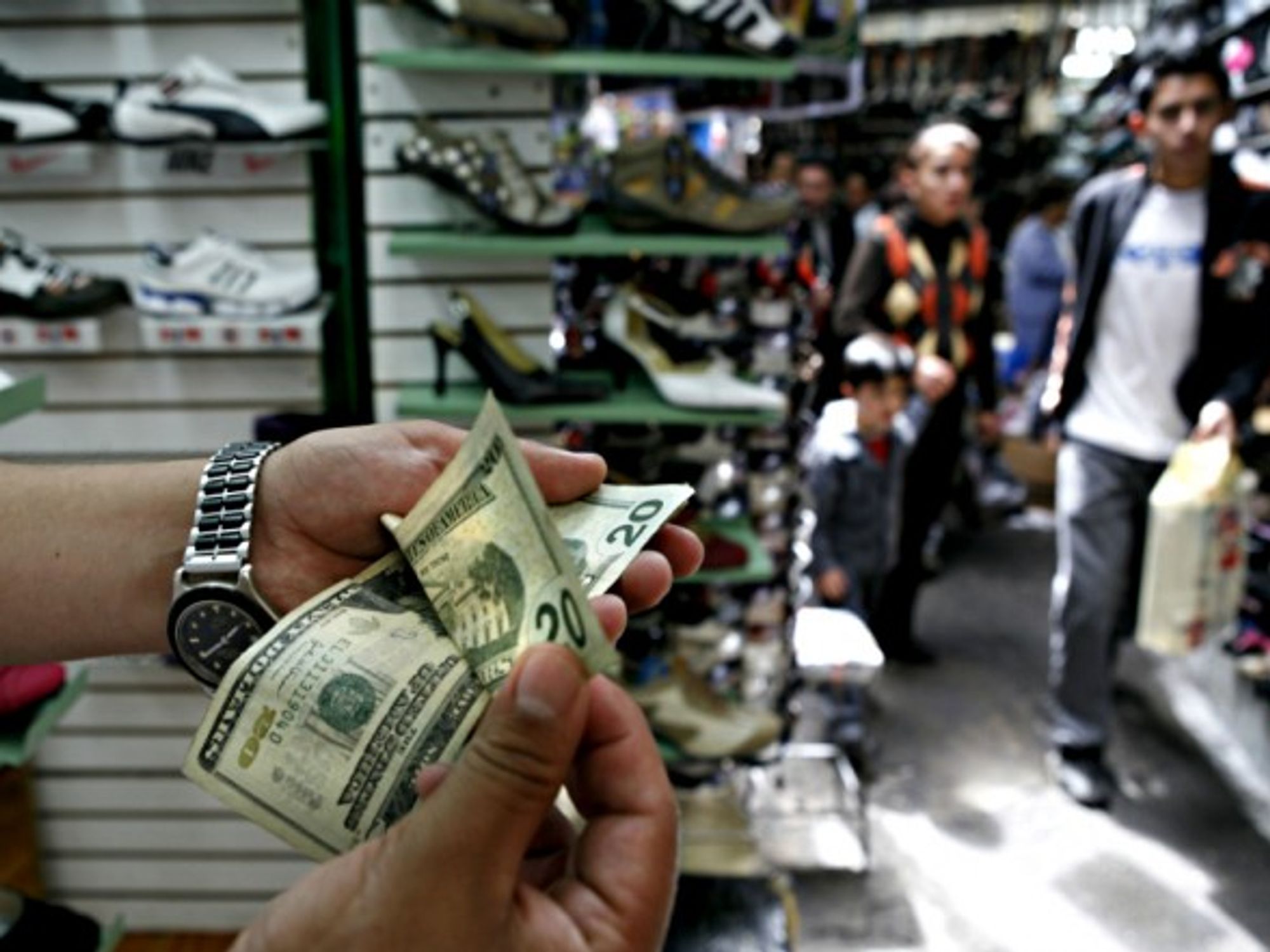 Counting dollar bills in a market in downtown Quito, Ecuador