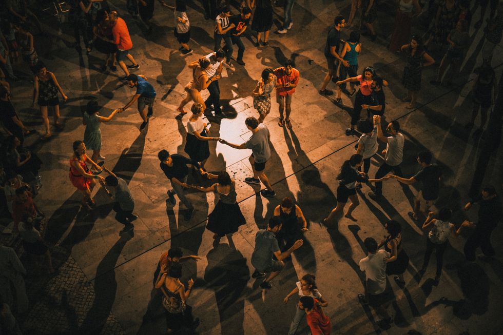 couples dancing outside at night in Lisbon, Portugal