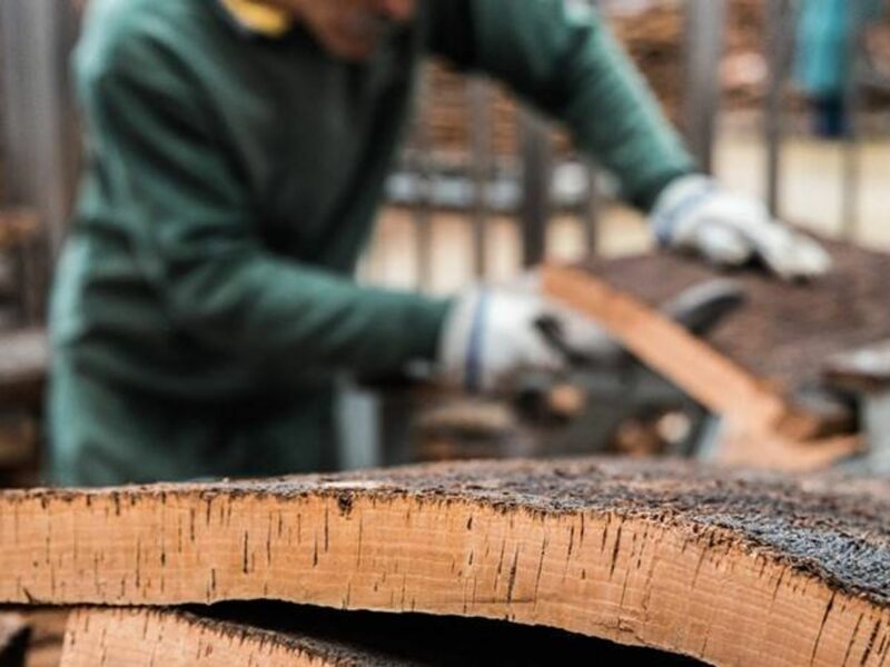 Craftsman slicing a piece of cork.