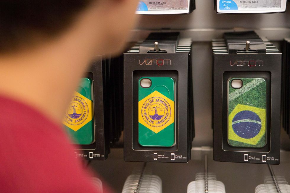 Customer selects iPhone shell with the image symbolize Rio de Janeiro and Brazil in a newly opened apple store in a Village Mall of Barra da Tijuca district in Rio de Janeiro, Brazil,