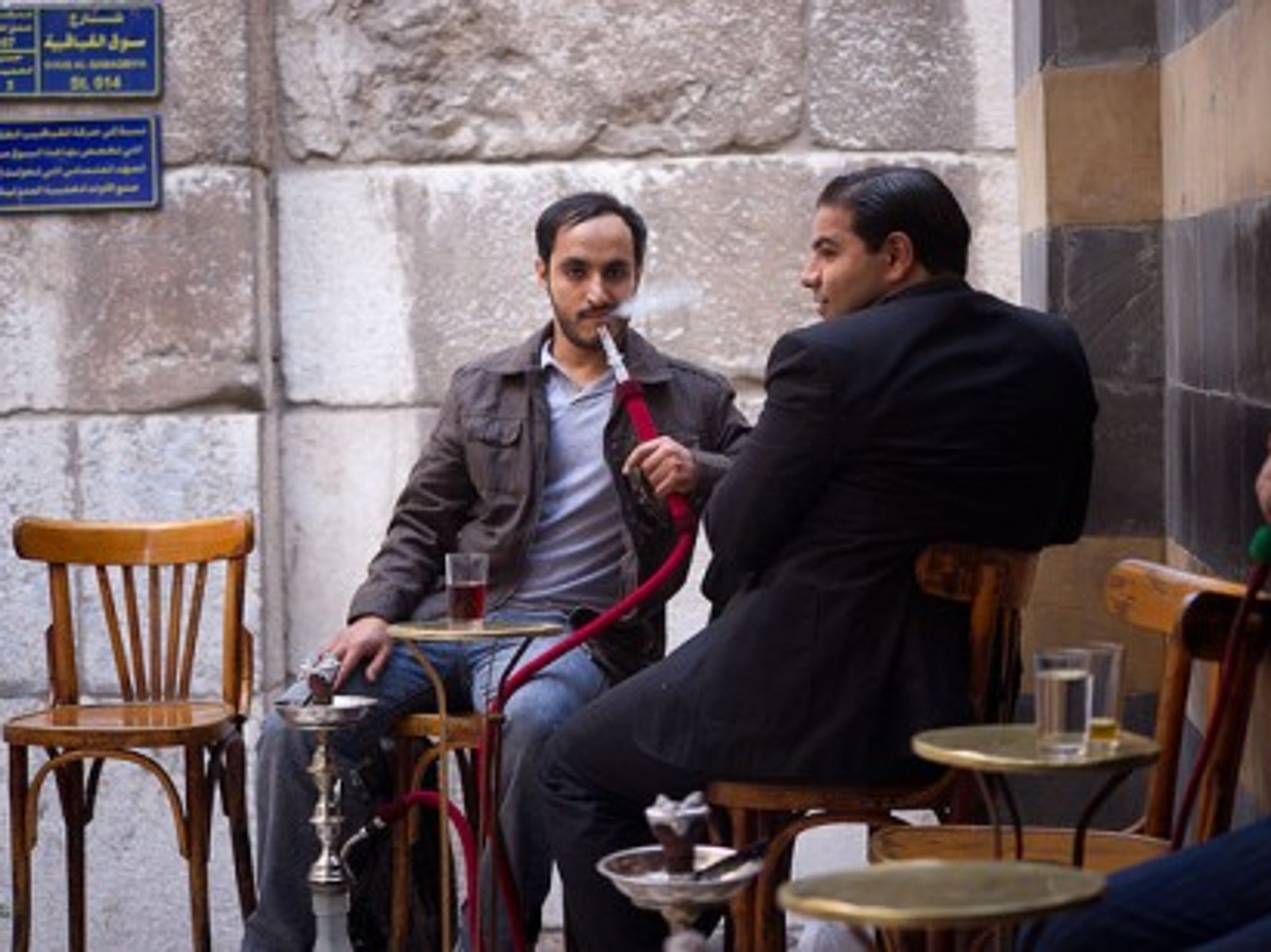 Customers in a Damascus café. Waiters are known to collect information overheard from clients.