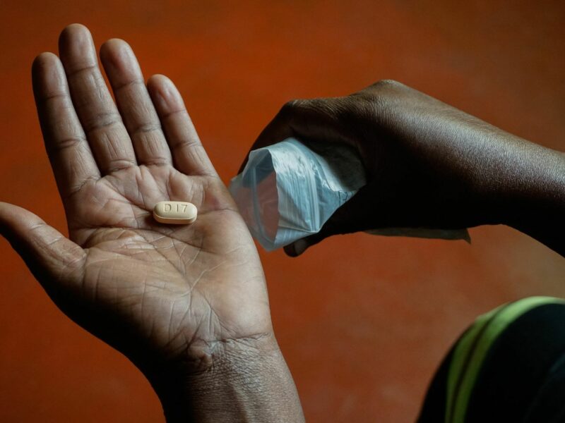 D17 pill in the hand of someone about to take medicationo