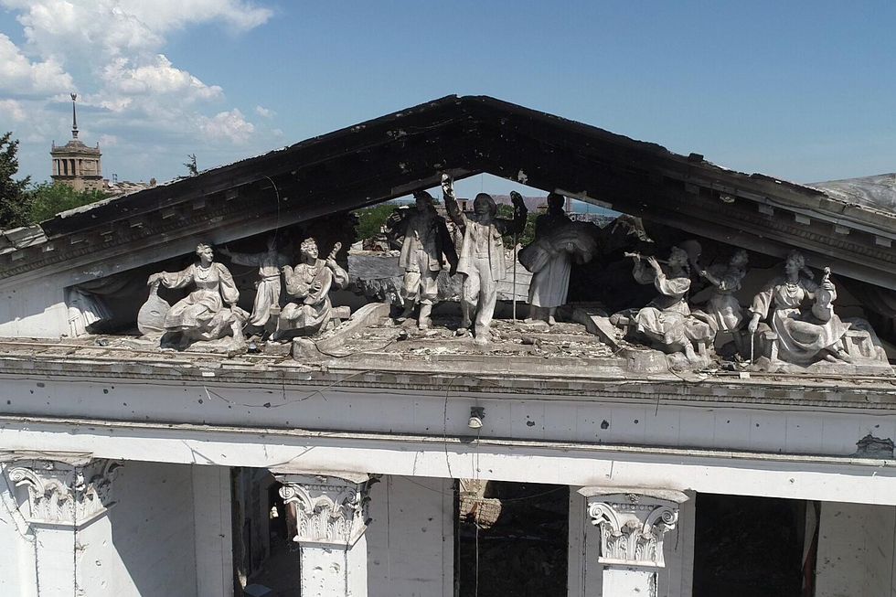 Damaged statues on top of the ruins of the Donetsk Region Russian Drama Theatre.