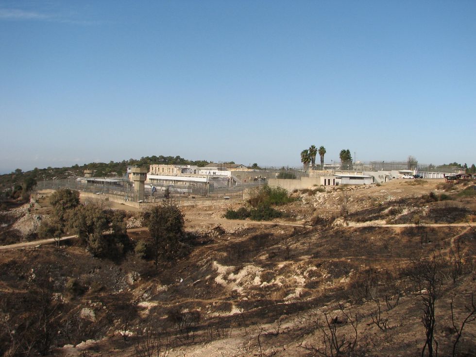 Damoun Prison sitting remotely amongst baron trees