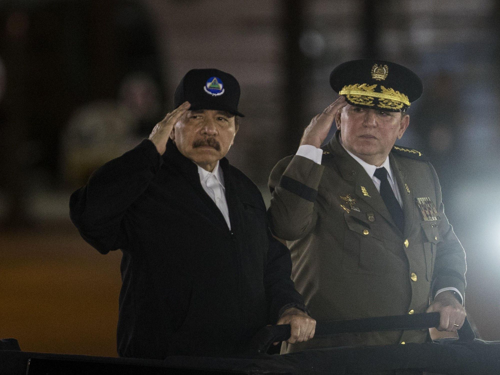 Daniel Ortega and General Aviles saluting