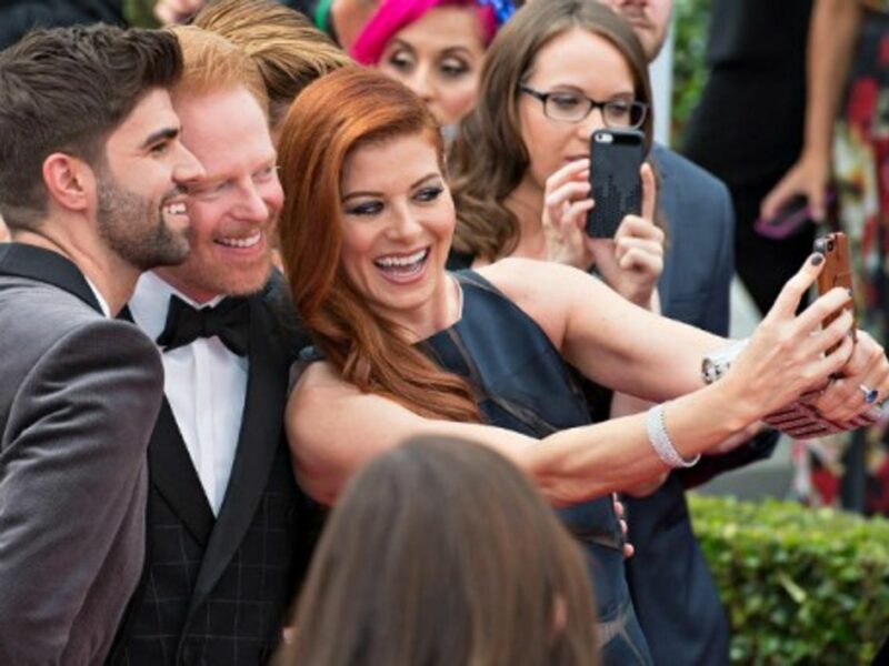 Debra Messing, Jesse Tyle and Justin Makita's snap selfie at the 2014 Emmy Awards