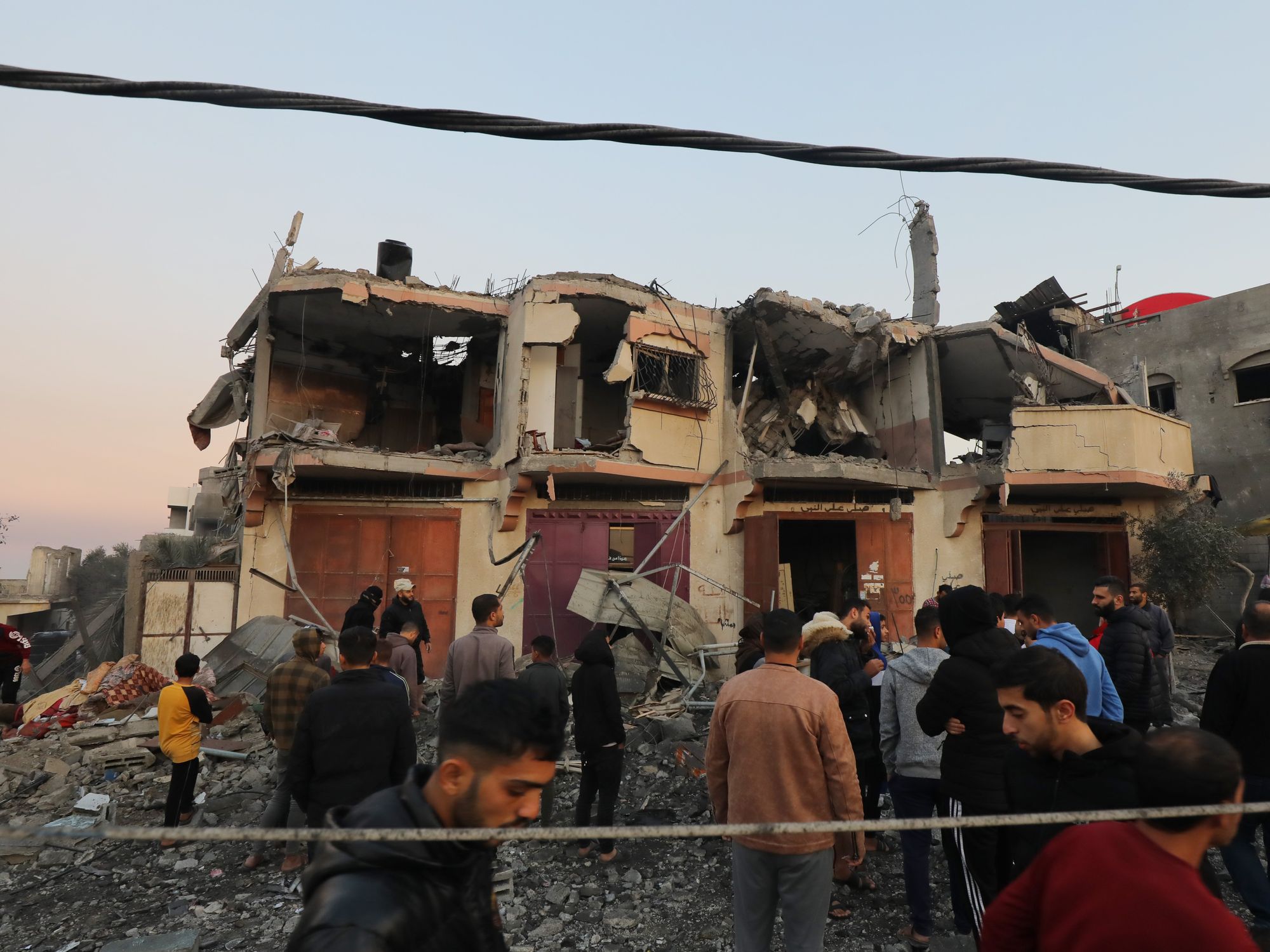 December 20, 2023, Dair El-Balah, Gaza Strip, Palestinian Territory: Palestinians inspect the damage to a residential building belonging following Israeli bombardment on Dair El-Balah central of Gaza Stri