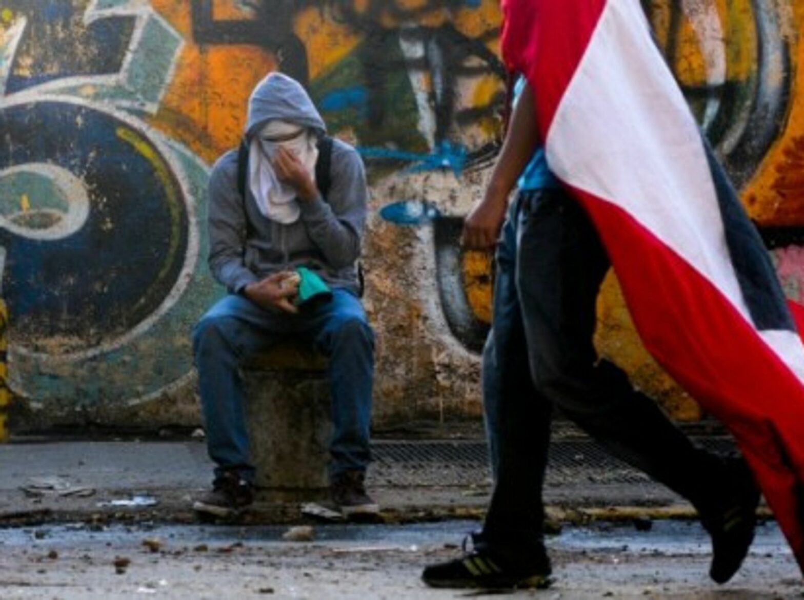 Demonstrations go on in Caracas as Venezuela marks Chavez' death one-year anniversary