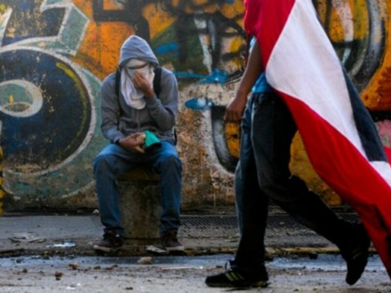 Demonstrations go on in Caracas as Venezuela marks Chavez' death one-year anniversary