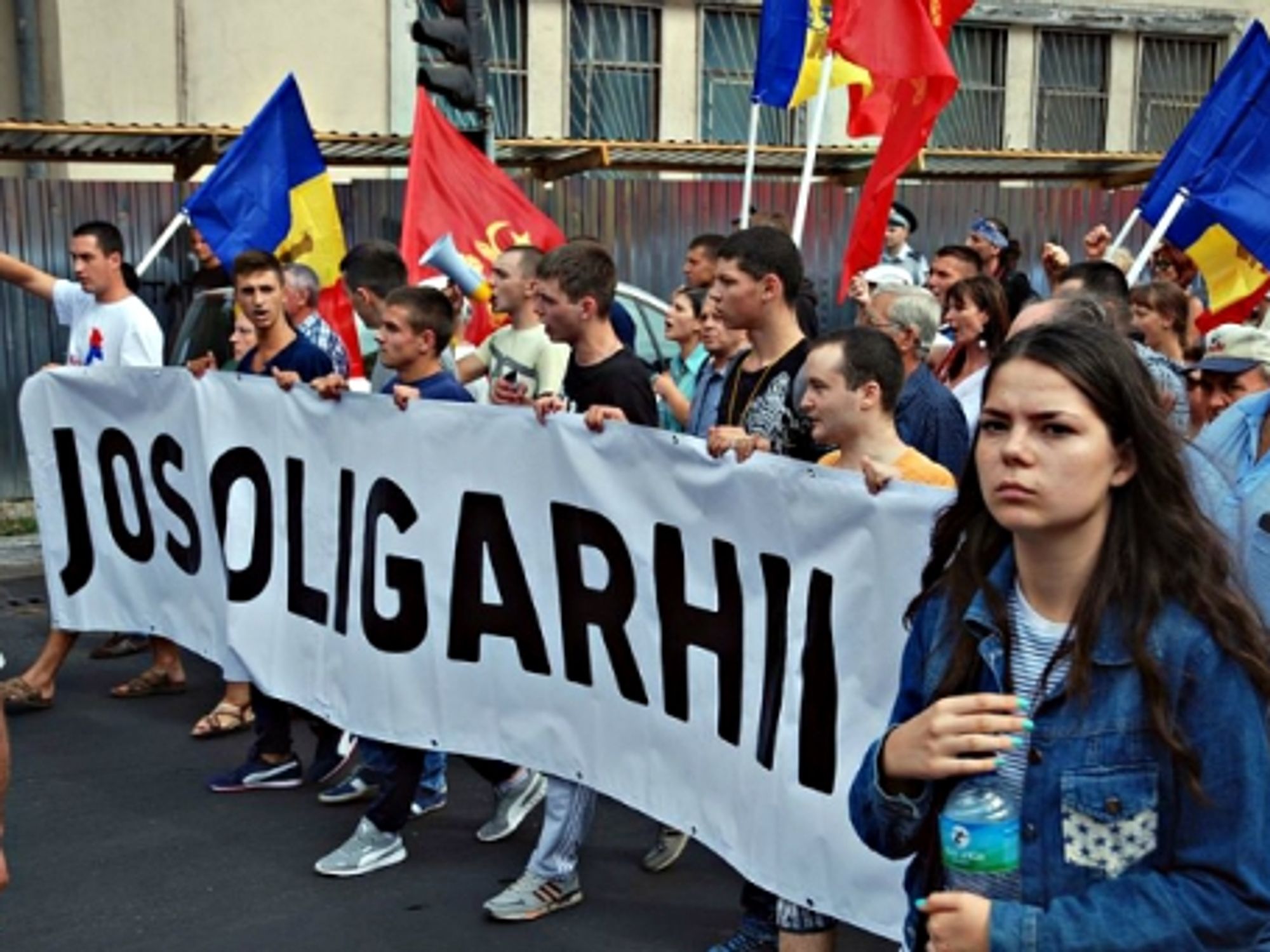 Demonstrators carrying an anti-oligarchy banner in Chisinau on Sept. 6