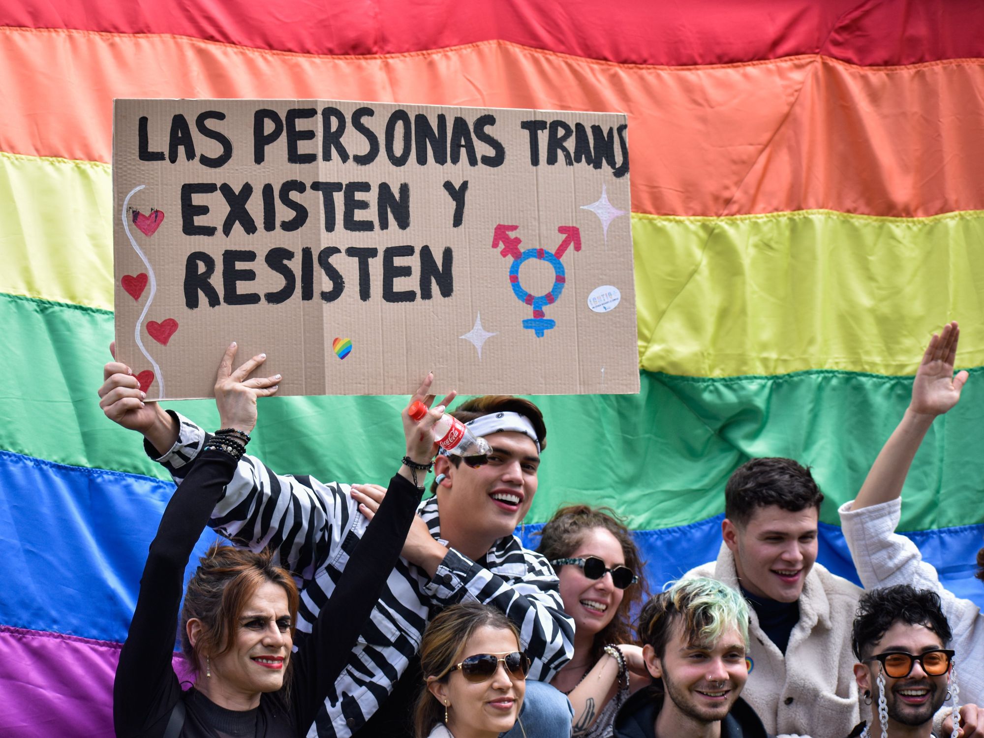 Demonstrators hold a sign that reads 'Transgender people exist and resist' during a LGTBIQ+ rights protest in Bogota, Colombia.