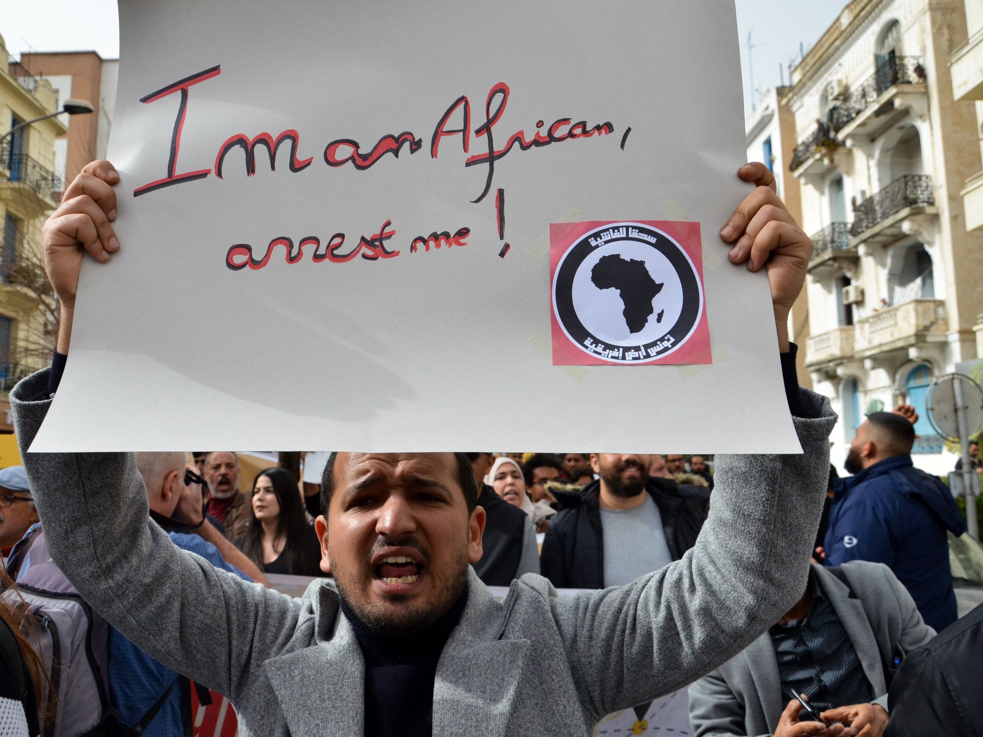 Demonstrators in Tunis holding a banner saying "I'm an African, arrest me !" in a fight against racism in the country and against President Kais Saied